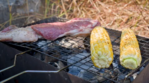 A slice of roast beef and a couple of grilled corn cobs. Stock Footage 244683345