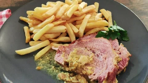 Slice of roast pork with mustard on a plate with fries Stock Footage 171343552