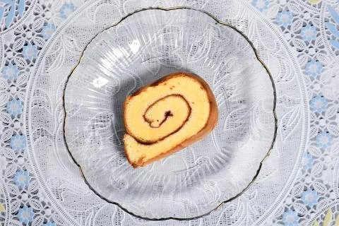 A slice of rolled cake with blueberry jam filling Stock Photos