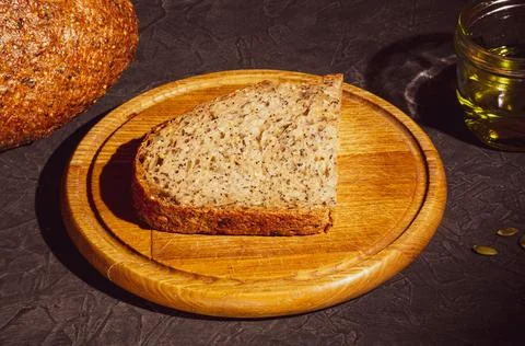 Slice of rustic natural yeast-free bread with flax, poppy seeds, sesame seeds Stock Photos