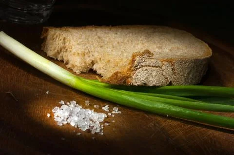 Slice of rye bread with young green onion Stock Photos