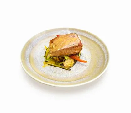 A slice of salmon cooked with vegetables in an elegant plate on a white bac.. Ilustração Stock