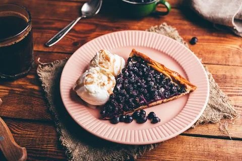 Slice of Serviceberry Pie and Two Scoops Of Vanilla Ice Cream Stock Photos