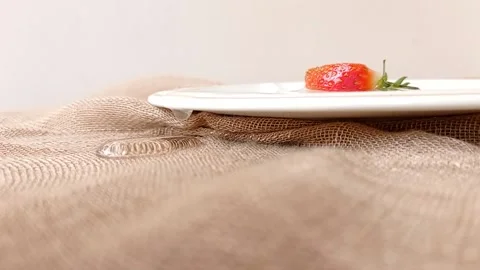 A slice of small strawberry on a white plate Stock Footage 146250407