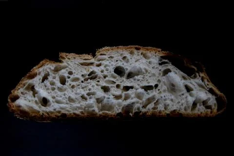 A slice of sourdough bread on a black background Stock Photos