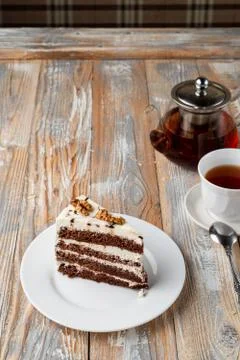 A slice of sponge honey cake with walnut and buttercream on old vintage table Stock Photos