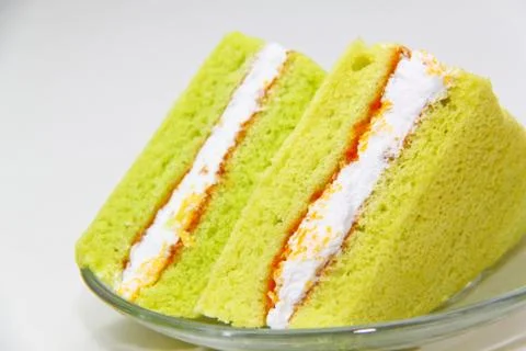 A slice of sponge pandan cake on white background Foto stock