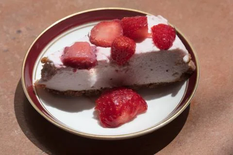 Slice of strawberry cheesecake Stock Photos