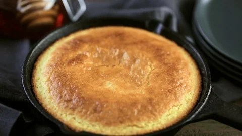 Slice of sweet cornbread with honey on the plate. Stock Footage 72200400