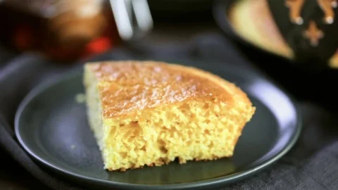 Slice of sweet cornbread with honey on the plate. Stock Footage 72200580