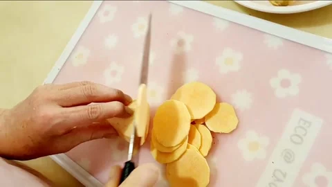 Slice sweet potatoes thinly Stock Footage 204838581