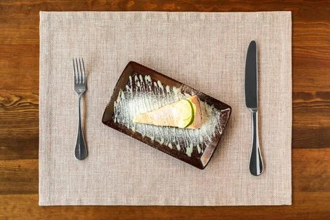 A slice of tender cheesecake with lemon Stock Photos