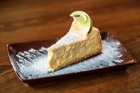 A slice of tender cheesecake with lemon Stock Photos