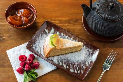 A slice of tender cheesecake with lemon Stock Photos