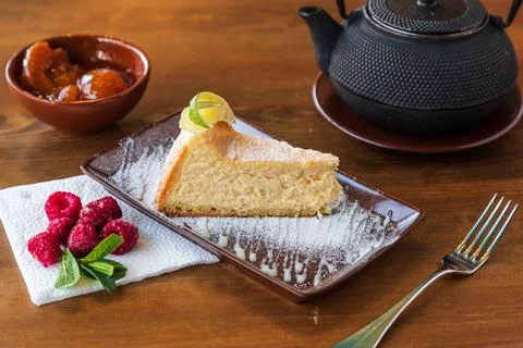 A slice of tender cheesecake with lemon Stock Photos