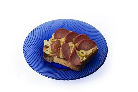 Slice of toasted bread with chickpeas hummus and fried salami Stock Photos