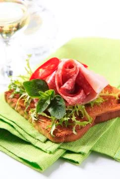 Slice of toasted bread with salami and ham Stock Photos