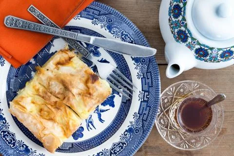 Slice of turkish borek served with a cup of tea Stock Photos