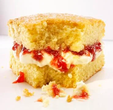 A slice of Victoria Sponge Cake with a bite take out Foto stock