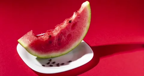 Slice of watermelon bite on red background. Stop motion animation Stock Footage 138632913