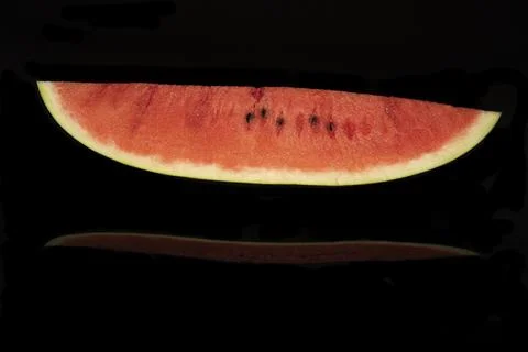 Slice of watermelon on black background. Stock Photos