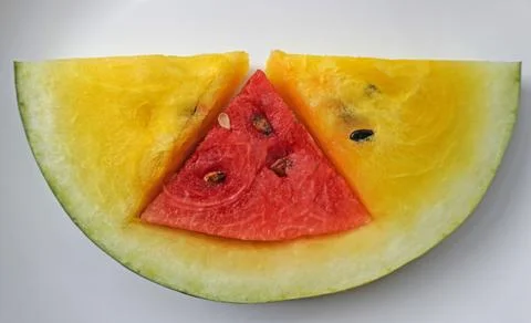 A slice of watermelon in the form of a red triangle located Foto stock
