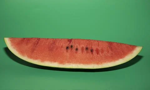 Slice of watermelon on green background Stock Photos