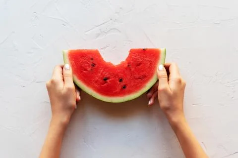 Slice of watermelon in hands on a white background Stock Photos