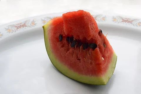 A slice of watermelon on a plate close-up. Stock Photos