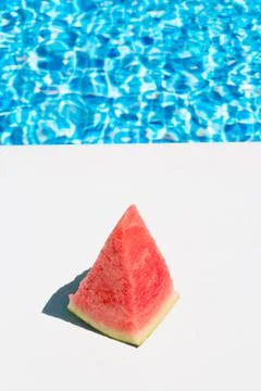 A slice of watermelon by the pool. concept of summer, holidays and food Stock Photos