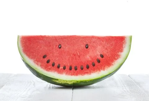 Slice of watermelon with seeds that make a smiling face Stock Photos