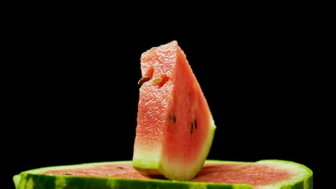 A slice of watermelon spinning on a black background. Stock Footage 160968441