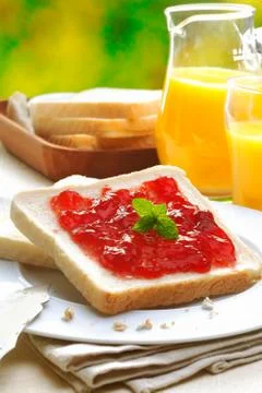 Slice of white bread and strawberry jam Stock Photos