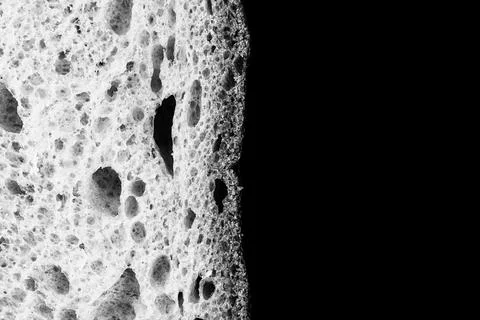 Slice of white bread close up isolated on black background. gray rough textur Foto stock