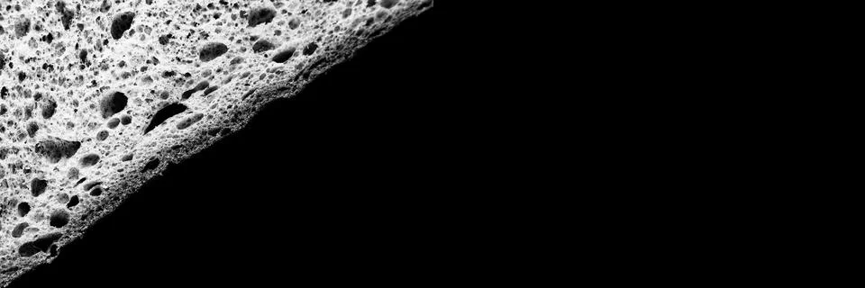Slice of white bread close up isolated on black background. gray textured sur Stock Photos