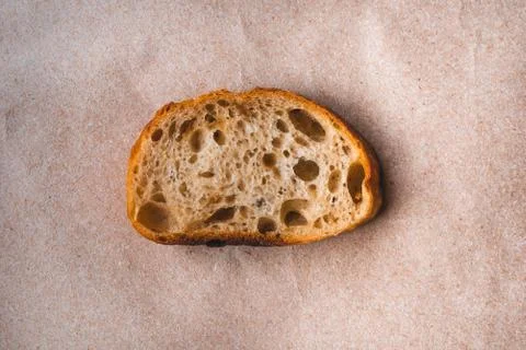 Slice of white bread on paper. Stock Photos