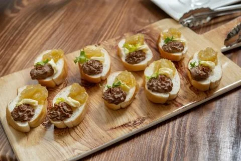 Slice white bread with smooth pate, decorated with leaf of salad, served on the Stock Photos