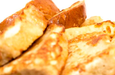 Slice of white bread toast on a white background. A butter pat in the shape o Stock Photos