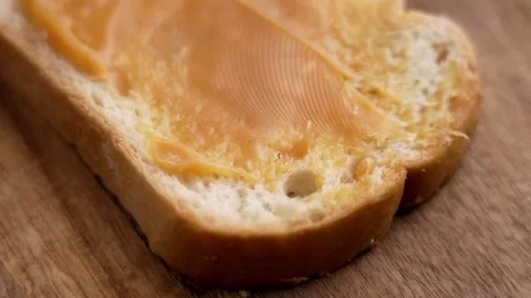 Slice of whole grain bread vegan sweetened condensed coconut paste Stock Footage 303854094