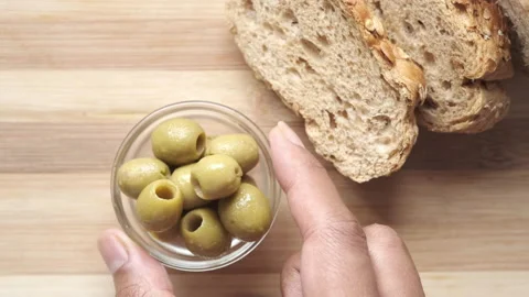 Slice of whole meal bread and olive oil on table Video stock 154735361