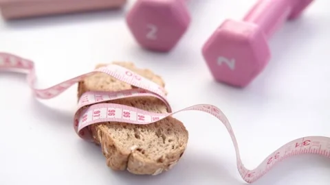 Slice of whole meal bread and measurement tape on table . Stock Footage 155625465