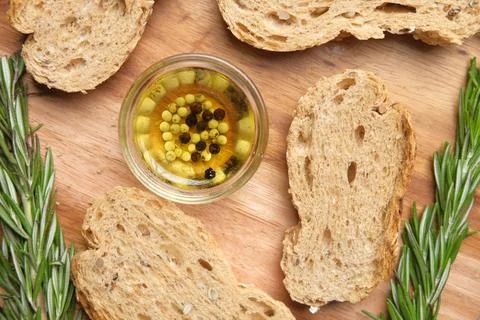 Slice of whole meal bread and olive oil on table Foto stock