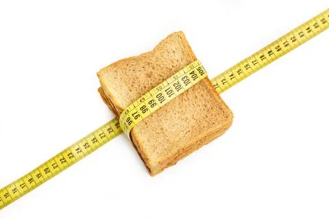 Slice of wholemeal bread with a tailor measuring tape Stock Photos