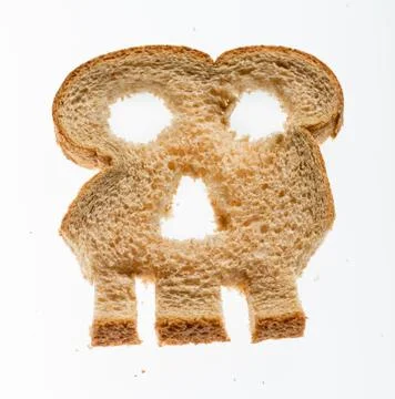 Slice of wholewheat bread in shape of skull Stock Photos