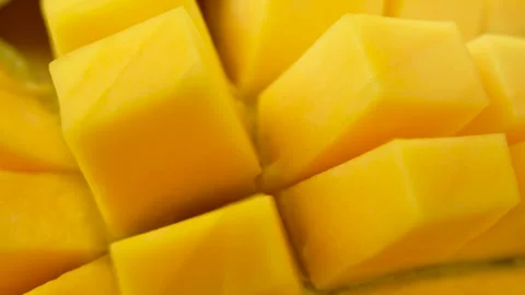 A slice of yellow mango with a green stem Video stock 304202914