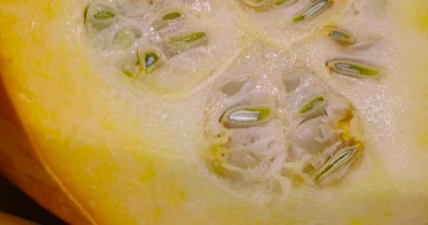 Slice yellow-orange ripe pumpkin or zucchini, slicing ripe zucchini on a black Stock Footage 311785403