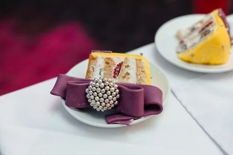 Slice of yellow tier sponge cake served on a white plate decorated with a Stock Photos