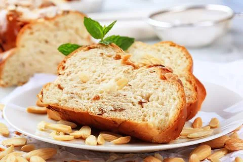 Sliced almond bread with mint garnish on plate 스톡 사진