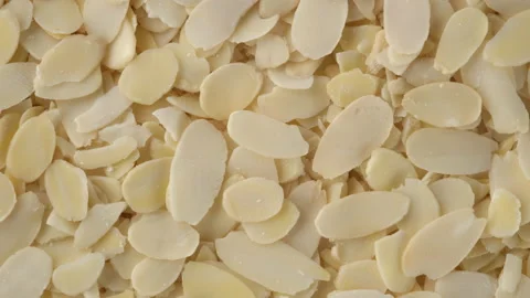 Sliced almonds top view, rotation. Healthy vegan food concept Stock Footage 172431377