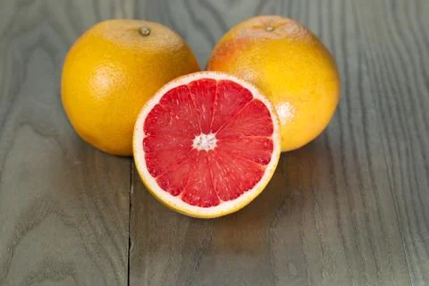 Sliced and whole ruby red grapefruits Stock Photos